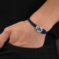buy-police-infiniti-bracelet-black-double-tour-blue-leather-with-antique-disc-and-iconic-p-emblemmen-s-bold-statement-style_ml9
